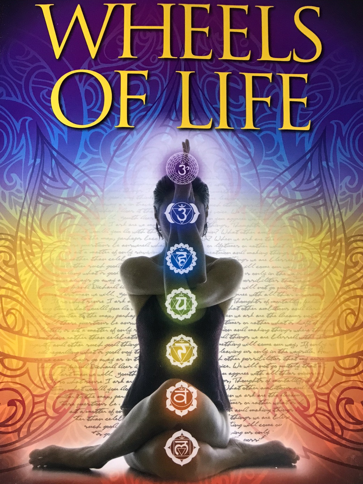 Silhouette of woman with chakra color symbols over her body. Text “Wheels of Life”